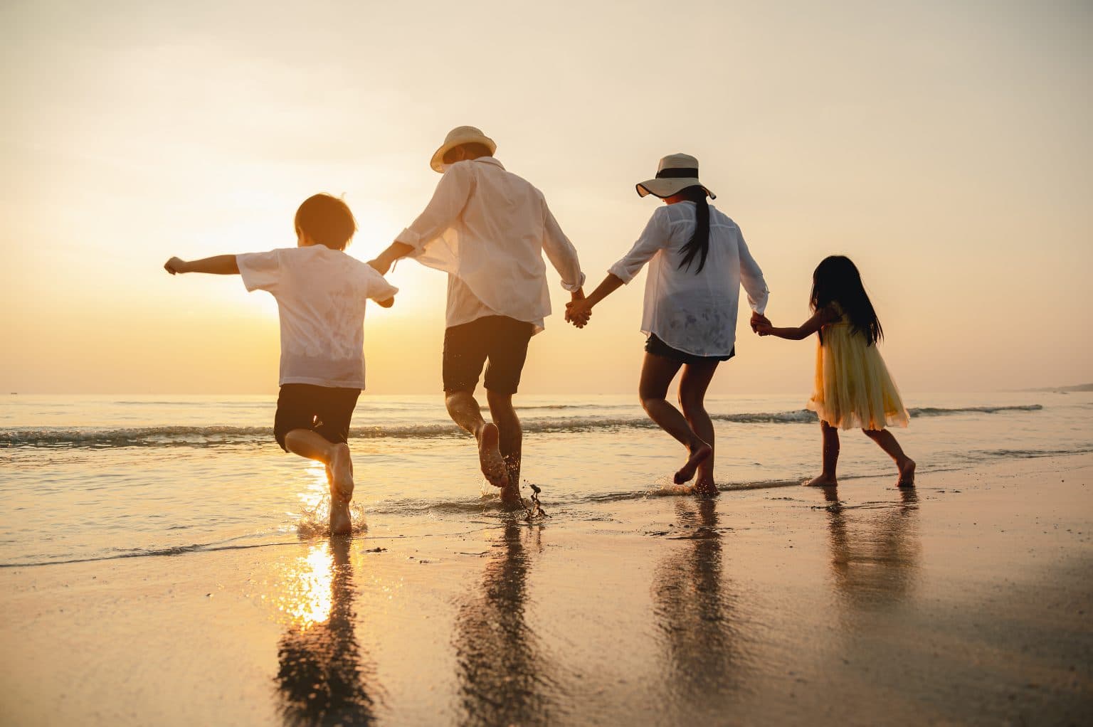 A family walking the Ocean City beach at sunset
